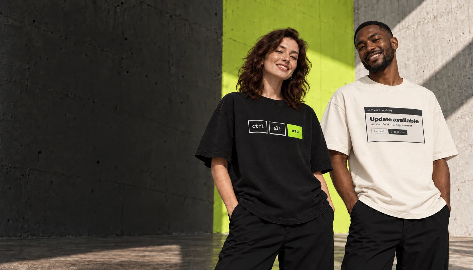 Two smiling models wearing mood.exe products: a black Ctrl / Alt / Esc tee and a cream Update Available tee.